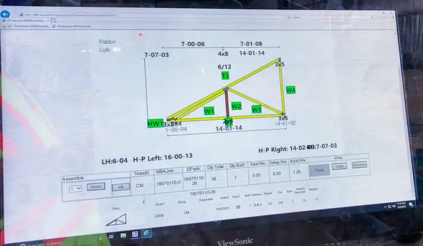 Monitor displaying a roof truss design drawing with dimensions and production data