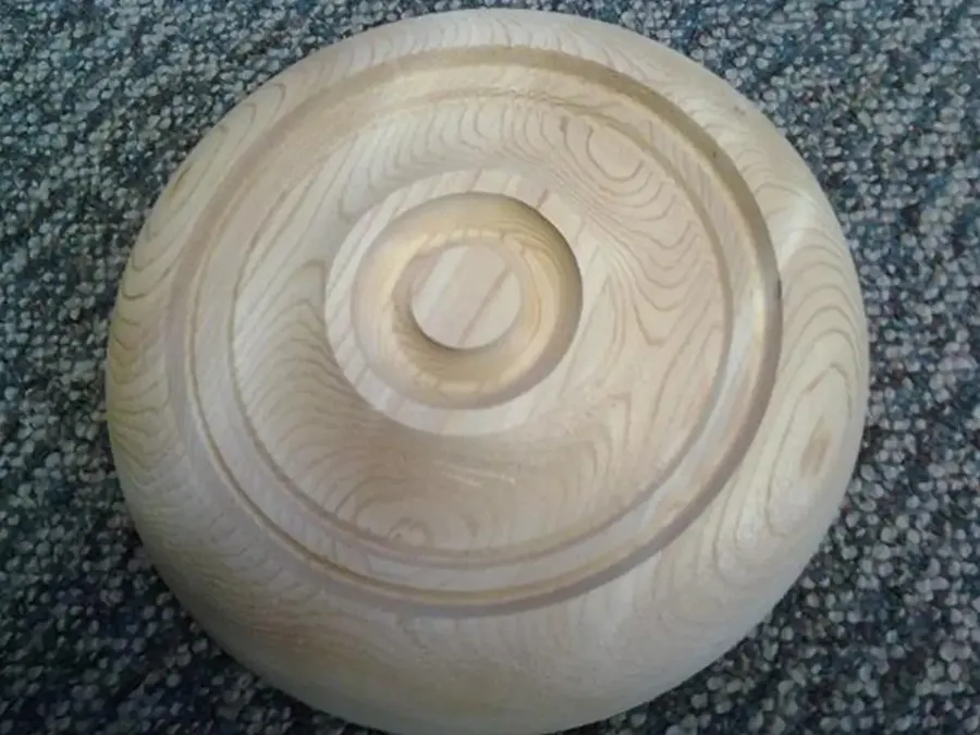 Unfinished turned wood rosette with concentric rings