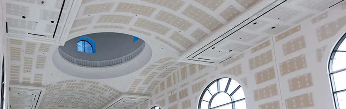 Vaulted drywall ceilings with a domed opening and arched windows